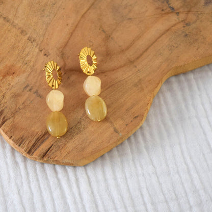 Détail des perles acryliques beige, montées à la main sur acier inoxydable doré à l’or fin